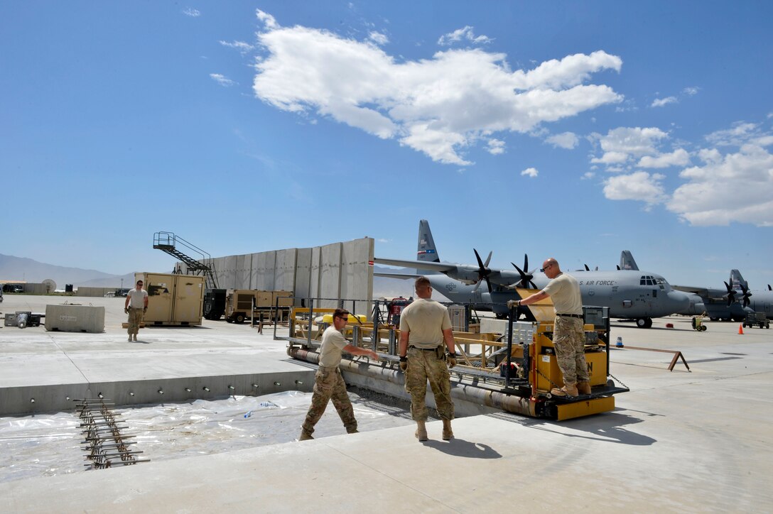 U.S. Air Force Airmen with the 455th Expeditionary Civil Engineer Squadron prepare to pour concrete on the flightline at Bagram Airfield, Afghanistan May 22, 2014. The 455 ECES ensures operability of the airfield by providing airfield maintenance, construction and operation for the senior airfield authority mission. (U.S. Air Force photo by Staff Sgt. Evelyn Chavez/Released)