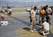 U.S. Air Force Airmen with the 455th Expeditionary Civil Engineer Squadron, grind down bolts on a polly pad on the flightline at Bagram Airfield, Afghanistan June 5, 2014. Grinding down the bolts is necessary to prevent aircraft from popping tires when running over the polly pad. (U.S. Air Force photo by Staff Sgt. Evelyn Chavez/Released)