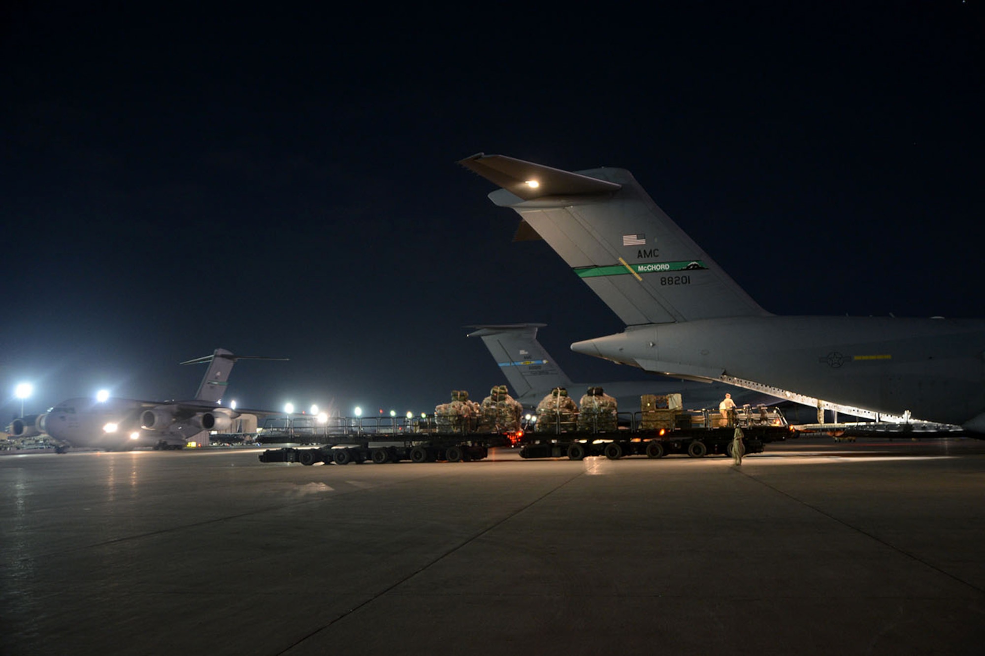 U.S. Air Force Airmen with the 455th Expeditionary Aerial Port Squadron load cargo into a C-17 Globemaster III loadmaster Sept. 9, 2014. Airmen assigned to the 455 EAPS have serviced more than 14,300 missions and 114,700 short tons of cargo since the beginning of the year to support Operation Enduring Freedom. (U.S. Air Force photo by Master Sgt. Cohen A. Young/Released)