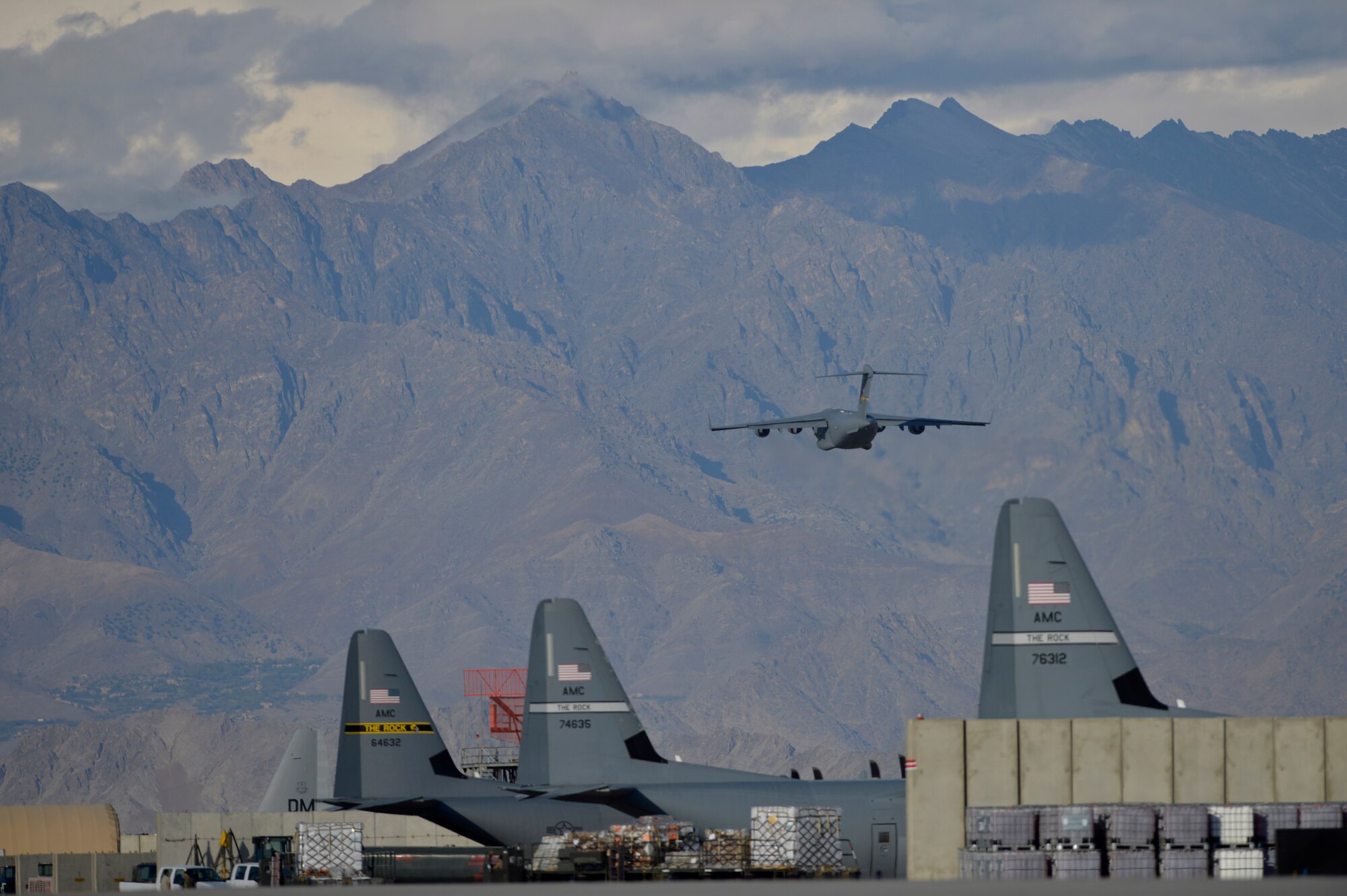 A U.S. Air Force C-17 Globemaster takes off into the mountains at Bagram Airfield, Afghanitan Oct. 23, 2014.  Since 2006, the annual airfield traffic count has increased from 143,705 to 333,610 as the support for Operation Enduring freedom nears its end. (U.S. Air Force photo by Staff Sgt. Evelyn Chavez/Released)