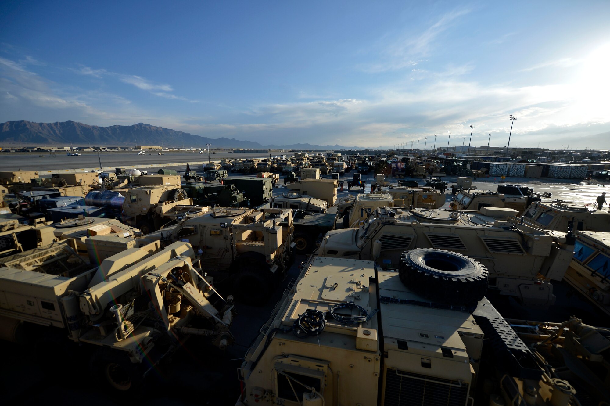 Military vehicles are lined up in the Expeditionary Aerial Port Squadron loading yard at Bagram Airfield, Afghanistan Oct. 23, 2014.  The 455 EAPS coordinates all equipment, personnel and life-saving supply movement that come into Afghanistan via the airfield.  They are the busiest aerial port squadron in the Department of Defense.  (U.S. Air Force photo by Staff Sgt. Evelyn Chavez/Released)