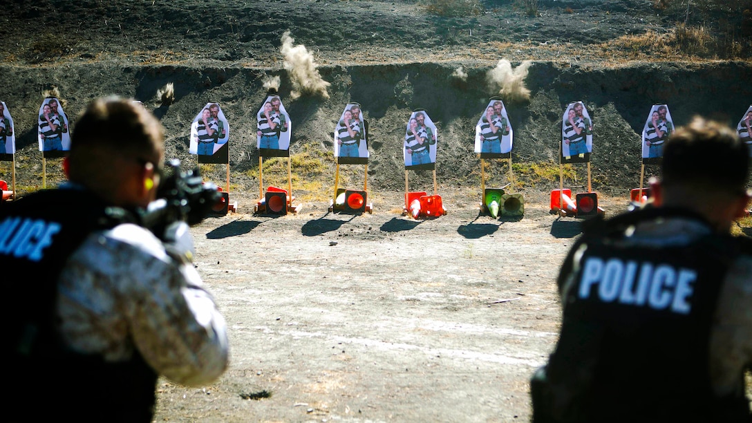 Marines with the Provost Marshall Office Special Reaction Team, engage targets holding hostages during a live-fire training evolution at Range 300, Oct. 23.  The SRT is responsible for any critical situations that fall beyond the capabilities of ordinary law enforcement. 