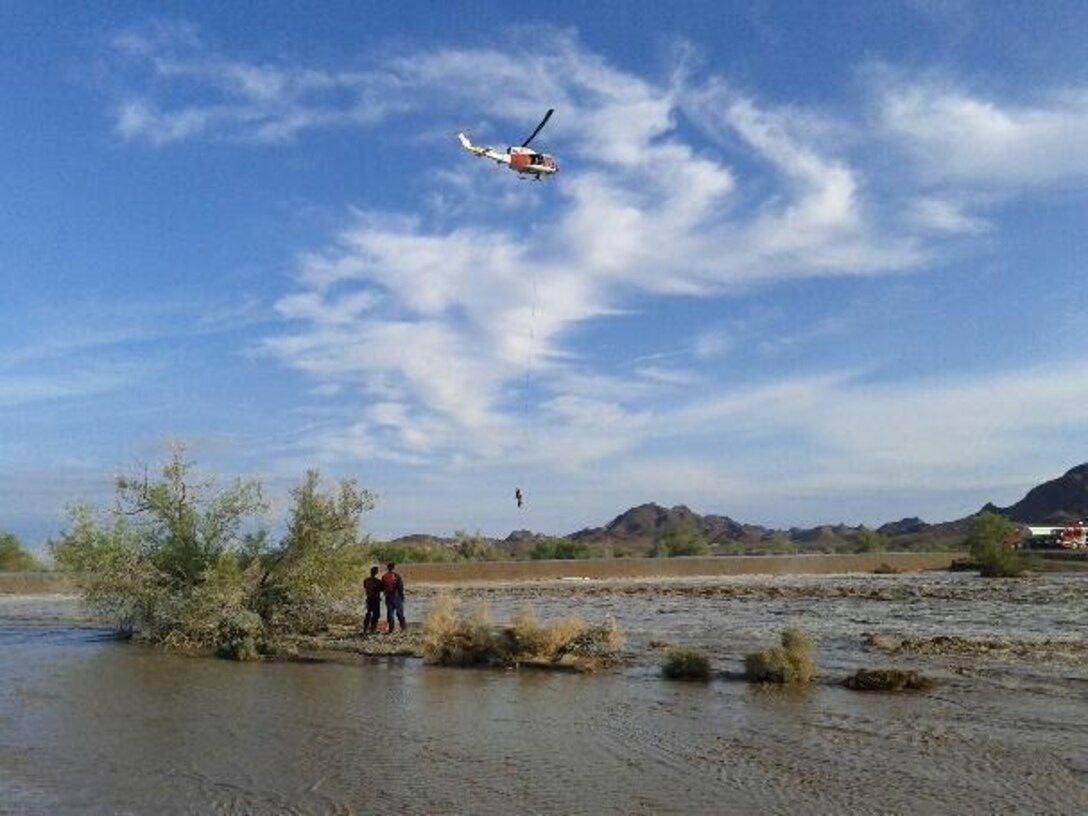 The Search and Rescue unit aboard Marine Corps Air Station Yuma, Ariz., conducted its second rescue mission of the week Wednesday. SAR teamed up with agencies from Riverside County, Calif., to successfully rescue a person that was stranded on top of a car that had been swept off Highway 78 by a flood. (Photo courtesy of U.S. Border Patrol)


