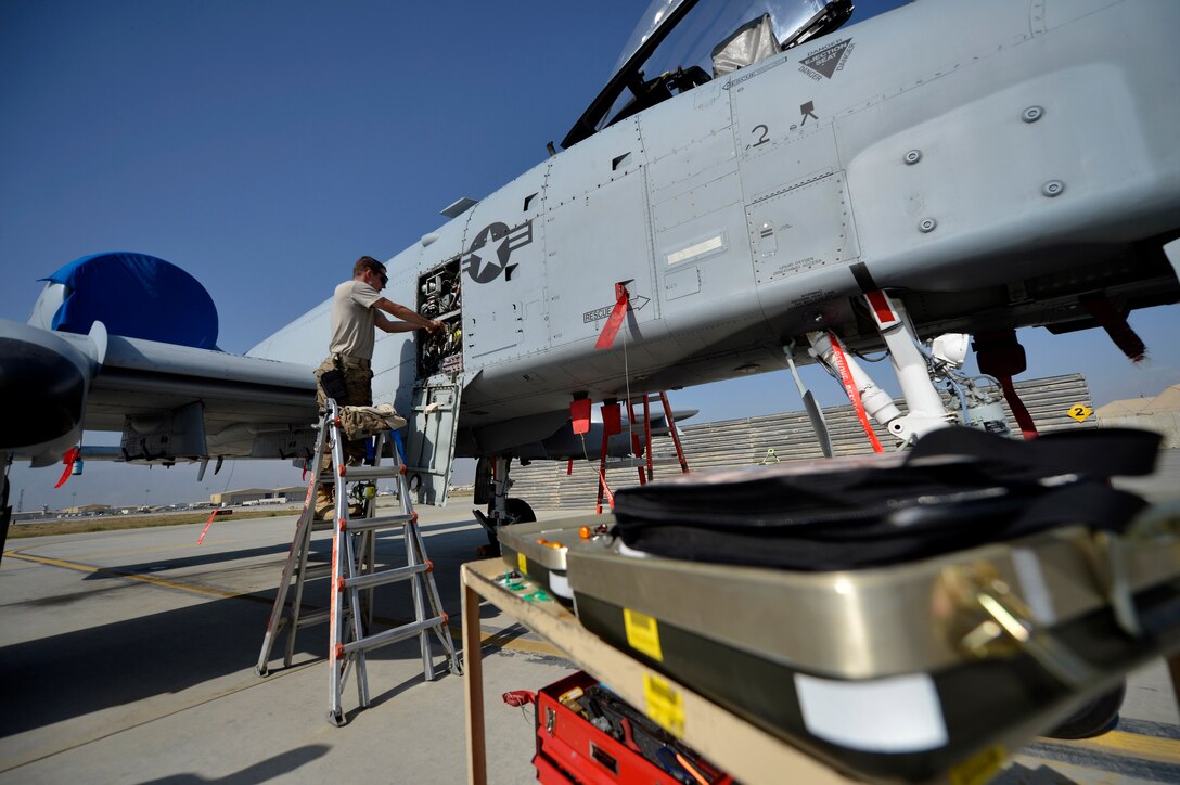 U.S. Air Force Senior Airman David Forker, 455th Expeditionary Aircraft Maintenance avionics systems technician, works on an A-10 Thunderbolt aircraft at Bagram Airfield, Afghanistan Oct. 24, 2014.  Forker deployed from Fort Wayne, Indiana Air National Guard, is responsible for ensuring the A-10 is mission ready and able to perform close air support missions throughout Afghanistan in support of Operation Enduring Freedom. (U.S. Air Force photo by Staff Sgt. Evelyn Chavez/Released)