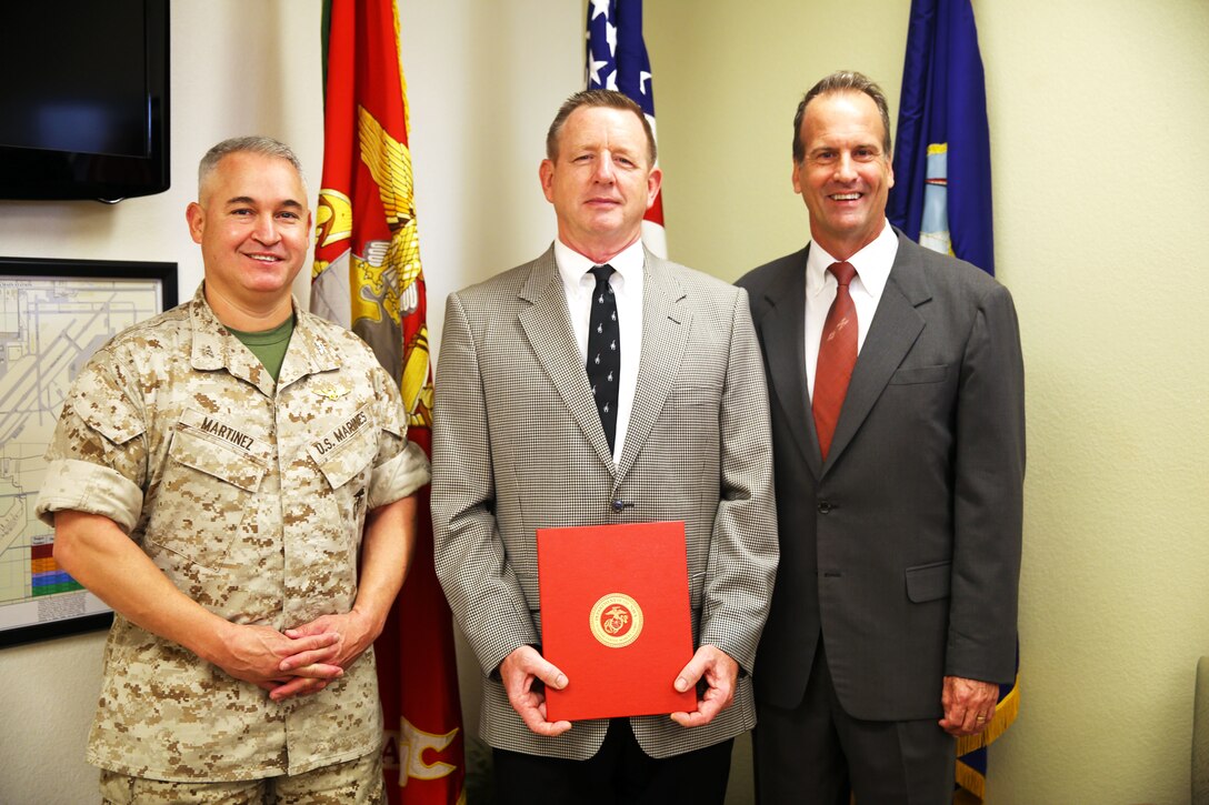 Daniel Karls, center, the legal counsel for Marine Corps Air Station Yuma, Ariz., receives the 35 Year Federal Length of Service Award from Col. Ricardo Martinez, left, the MCAS Yuma commanding officer. Darren Jump, right, the legal counsel for western Marine Corps installations, also attended the presentation. The installation command counsel office provides timely and candid legal advice, counsel, and advocacy.