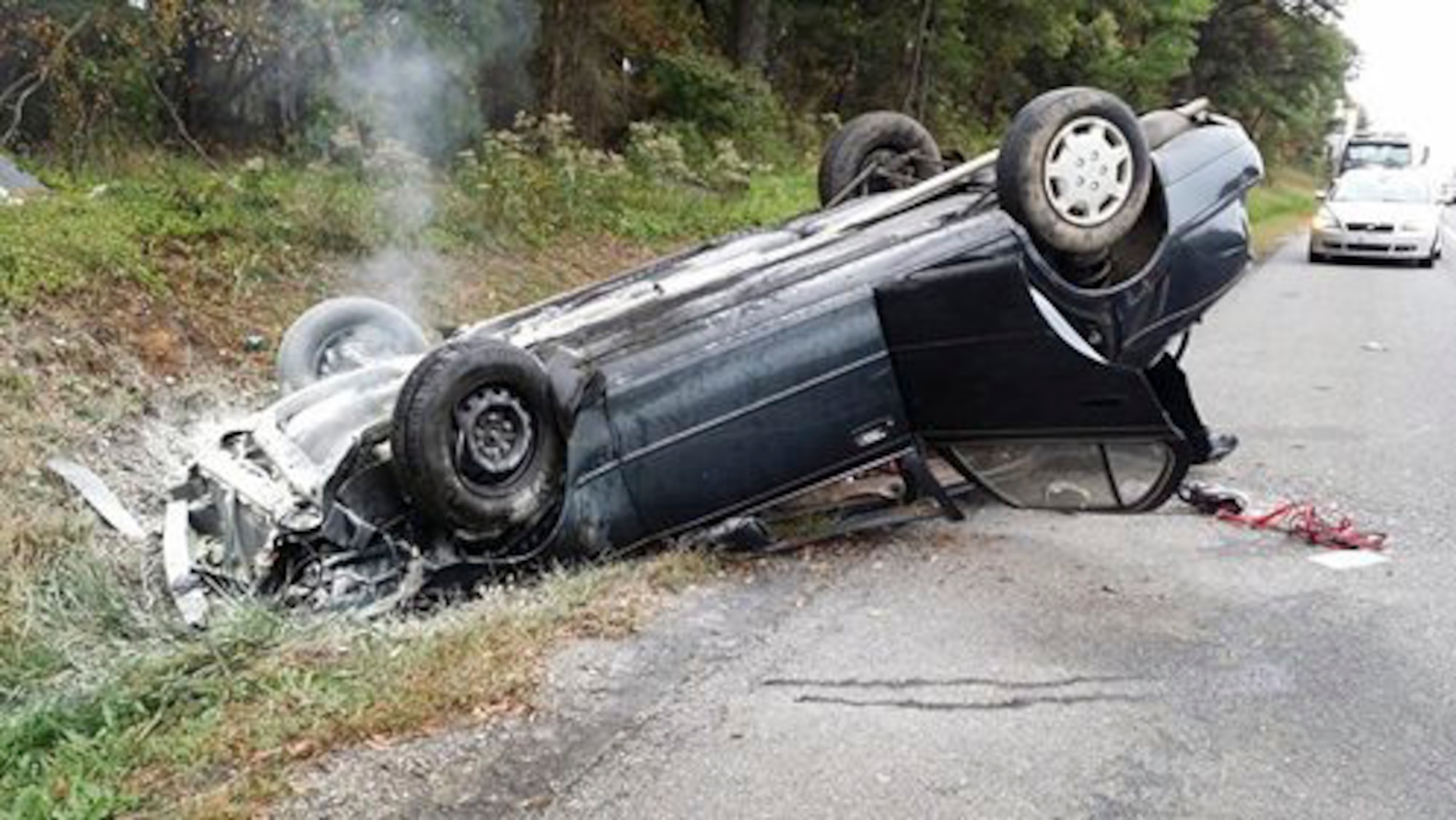 A crashed car sits on the side of Interstate 495 on Oct. 16, 2014, in Washington D.C. The 62-year-old, identified as Hilda, swerved off the road, hit a tree causing it to roll. Shortly after, Staff Sgt. Andrew Smith, a 89th Communications Squadron program manager, came to her aid and helped emergency services tend to the victim. (Courtesy photo)