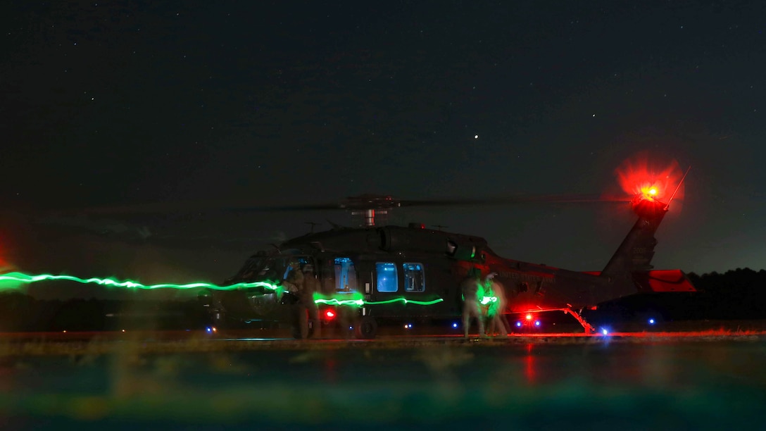 Marines with Marine Aerial Refueler Transport Squadron 252 connect a fuel hose from a KC-130J Super Hercules to a UH-60 Black Hawk during air-delivered ground refueling training at Wright Army Airfield, Ga., Oct. 22, 2014. ADGR allows aircraft unable to refuel in-flight to land, refuel and resume mission support. The Super Hercules belongs to the Marines of Marine Aerial Refueler Transport Squadron 252 and the Black Hawk belong to the Army’s 160th Special Operations Aviation Regiment (Airborne).