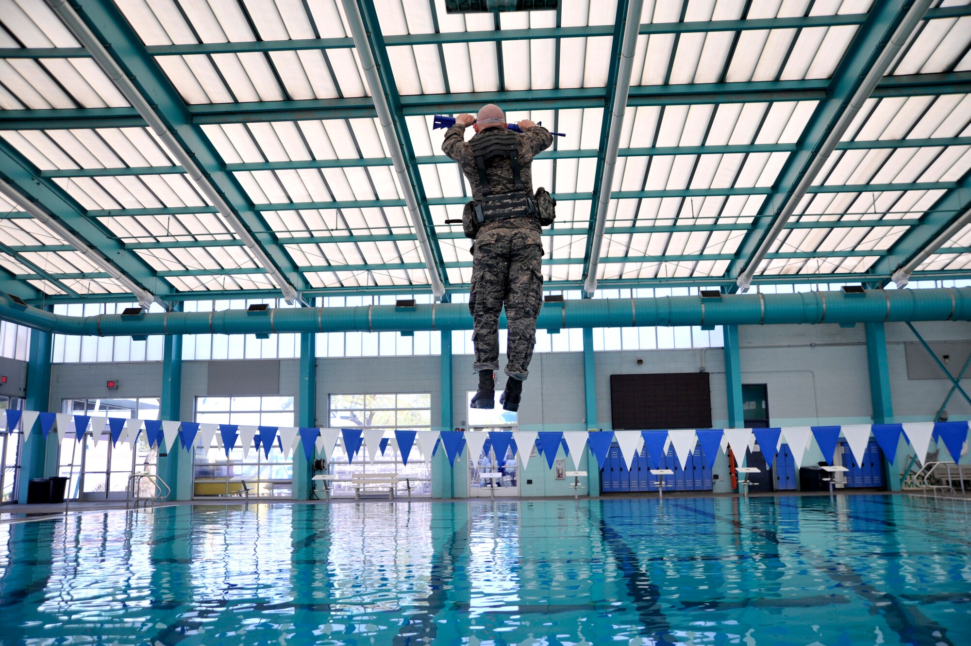 A Ranger Assessment Course student is pushed into a pool as part of the combat water survival portion of RAC, Oct. 2, 2014, in Las Vegas. Before entering the water, students wear blacked out goggles and are spun three times before being blindly pushed into the pool by an instructor. (U.S. Air Force photo/Airman 1st Class Christian Clausen)