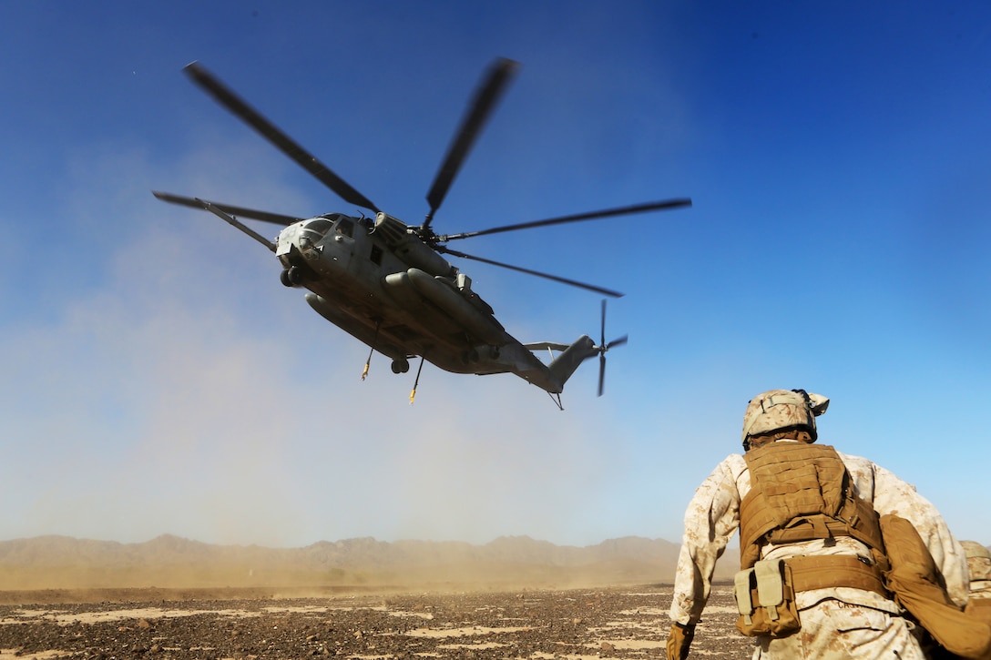 Lance Cpl. Christopher Gauntt, a landing support specialist with Combat Logistics Battalion 13, prepares to connect simulated cargo to a CH-53E Super Stallion with Marine Heavy Helicopter Squadron (HMH) 462 aboard Marine Corps Air Station Yuma, Ariz., Oct. 23. The training helped the Marines experience the effects of the aircraft while trying to attach the cargo.