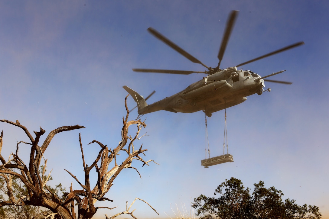 A CH-53E Super Stallion with Marine Heavy Helicopter Squadron (HMH) 462 lifts a decommissioned rocket pod during training with a Helicopter Support Team (HST) with Combat Logistic Battalion (CLB) 13 aboard Marine Corps Air Station Yuma, Ariz., Oct. 23. HMH-462 transported simulated cargo while the HST conducted training which included connecting and disconnecting cargo.
