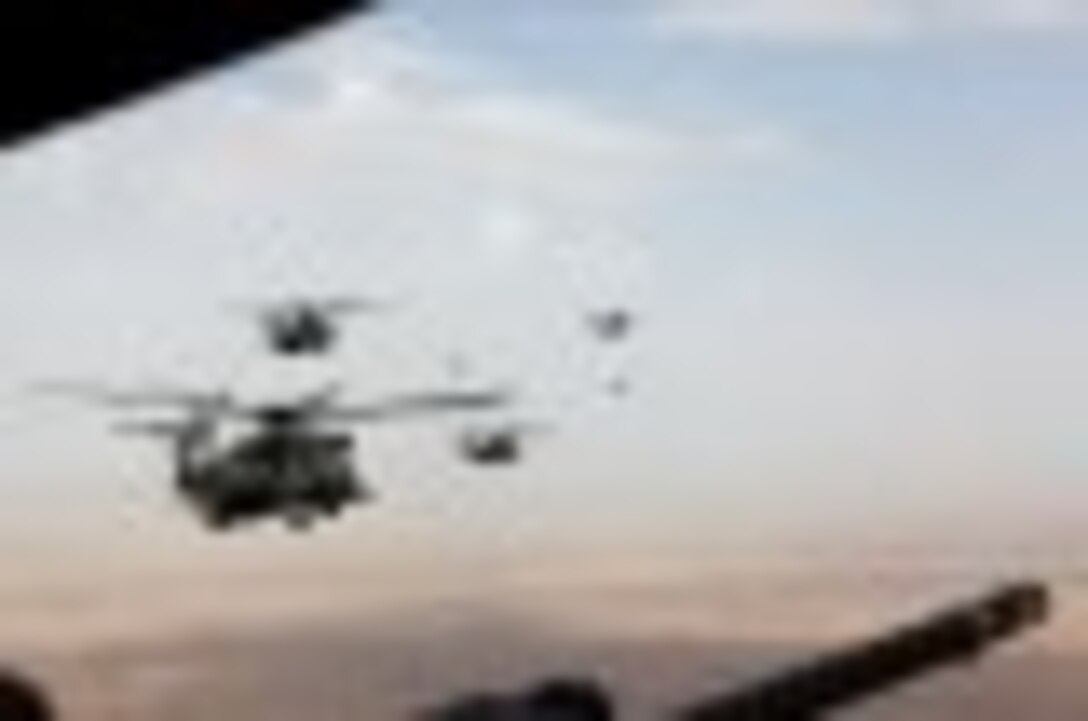 Marine Corps and Royal Air Force helicopters fly in formation after departing Camp Bastion, Afghanistan, Oct. 27, 2014. The Marine Corps ended operations in Helmand province and transferred the base to the Afghan National Army.