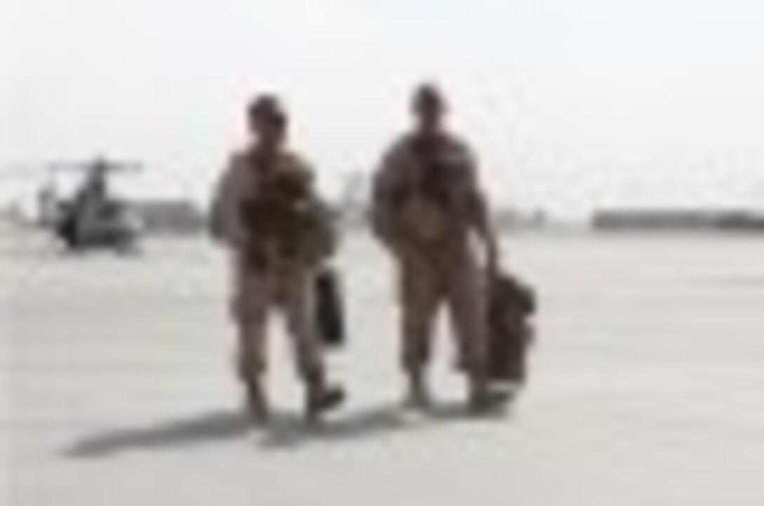 Brigadier Gen. Daniel D. Yoo, left, commanding general, Marine Expeditionary Brigade – Afghanistan, and Sgt. Maj. Doug Berry Jr., sergeant major, MEB-A, exit a UH-1Y Huey following their landing at Kandahar Airfield in Kandahar province, Afghanistan, Oct. 27, 2014. The Marine Corps ended operations in Helmand province and transferred Camps Bastion and Leatherneck to the Afghan National Army.