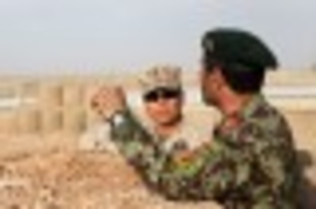 Brigadier Gen. Daniel D. Yoo, commanding general, Marine Expeditionary Brigade – Afghanistan, speaks with Maj. Gen. Sayed Malouk, the commander of the Afghan National Army’s 215th Corps, about the perimeter of Camp Leatherneck, Oct. 27, 2014. The United States Marine Corps ended their operations in Helmand province, Afghanistan, and transferred the base to the ANA.