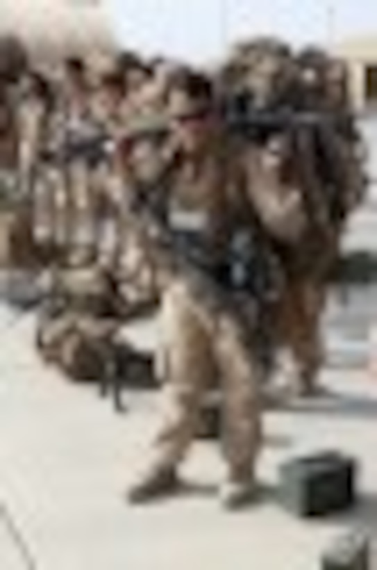 A Marine with 1st Battalion, 2nd Marine Regiment, prepares to load onto a KC-130 aircraft on the Camp Bastion flightline, Oct. 27, 2014. The battalion was the final Marine Corps infantry battalion to serve in Helmand province, Afghanistan, as the United States Marine Corps ended their operations.