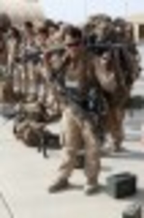 A Marine with 1st Battalion, 2nd Marine Regiment, prepares to load onto a KC-130 aircraft on the Camp Bastion flightline, Oct. 27, 2014. The battalion was the final Marine Corps infantry battalion to serve in Helmand province, Afghanistan, as the United States Marine Corps ended their operations.