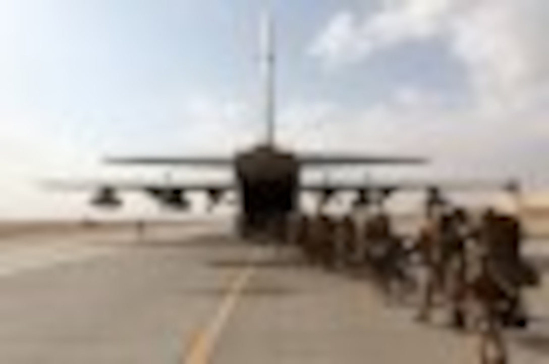 Marines and sailors with Marine Expeditionary Brigade – Afghanistan load onto a KC-130 aircraft on the Camp Bastion flightline, Oct. 27, 2014. The Marine Corps ended its mission in Helmand province, Afghanistan, the day prior and all Marines, sailors and service members from the United Kingdom withdrew from southwestern Afghanistan.