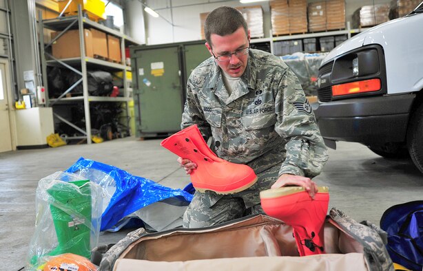 U.S. Air Force Staff Sgt. Brent Wood, 35th Civil Engineer Squadron Readiness and Emergency Management Flight NCO in charge of plans and operations, checks his emergency response gear at Misawa Air Base, Japan, Oct. 28, 2014. During natural or man-made disasters, Woods is one of the first to respond to the crisis situation. (U.S. Air Force photo by Senior Airman Jose L. Hernandez-Domitilo/Released)