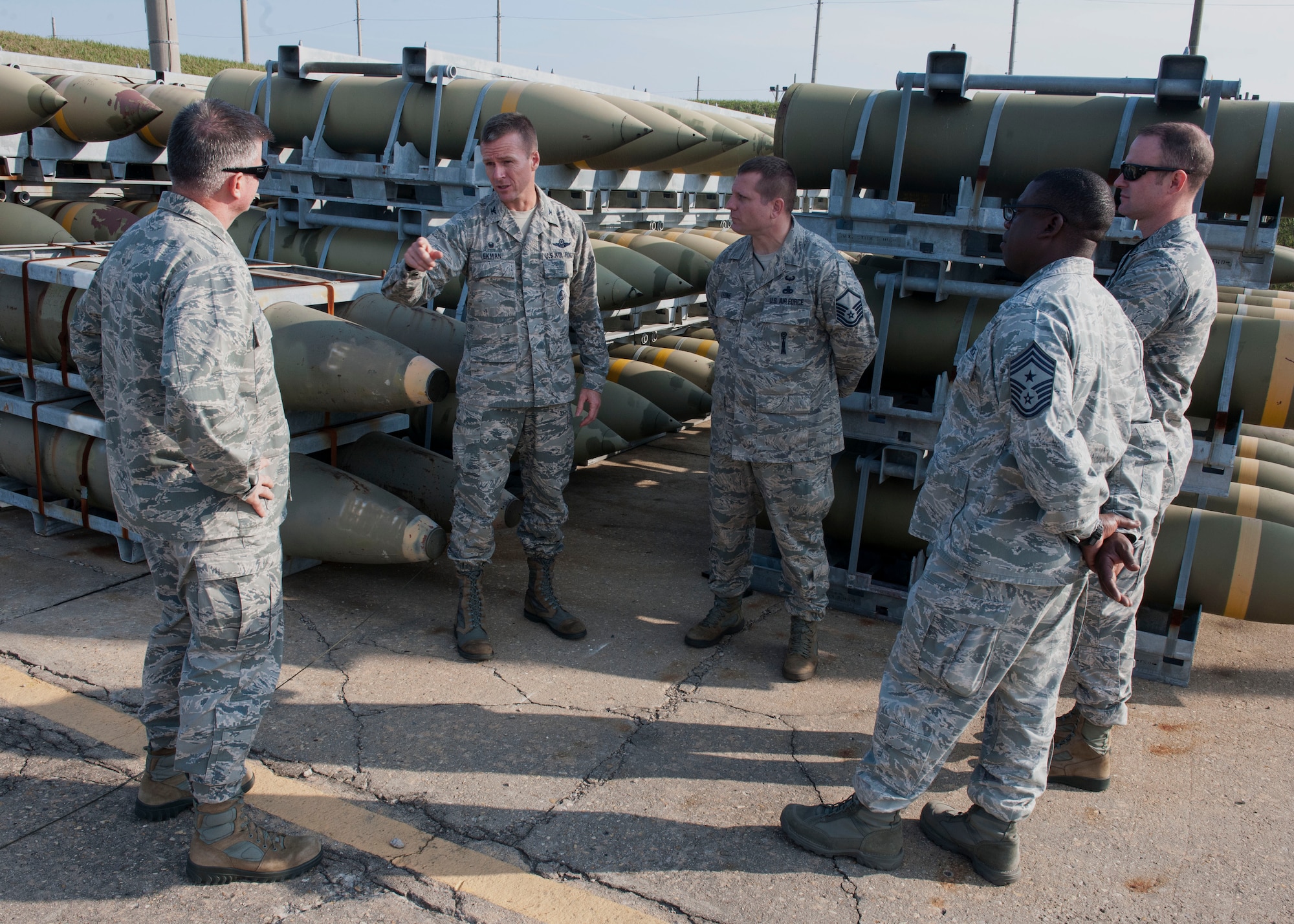 Col. Ken "Wolf" Ekman, 8th Fighter Wing commander (center, left), speaks to 8th Maintenance Group leadership following a successful Emergency Destruction of Munitions simulation, held in conjunction with Exercise Beverly Midnight 15-1, Oct. 23, 2014. EDM would be conducted to prevent enemies from gaining access to critical assets at Kunsan Air Base to use against the U.S. Armed Forces and its allies. (U.S. Air Force photo by Senior Airman Katrina Heikkinen/ Released)