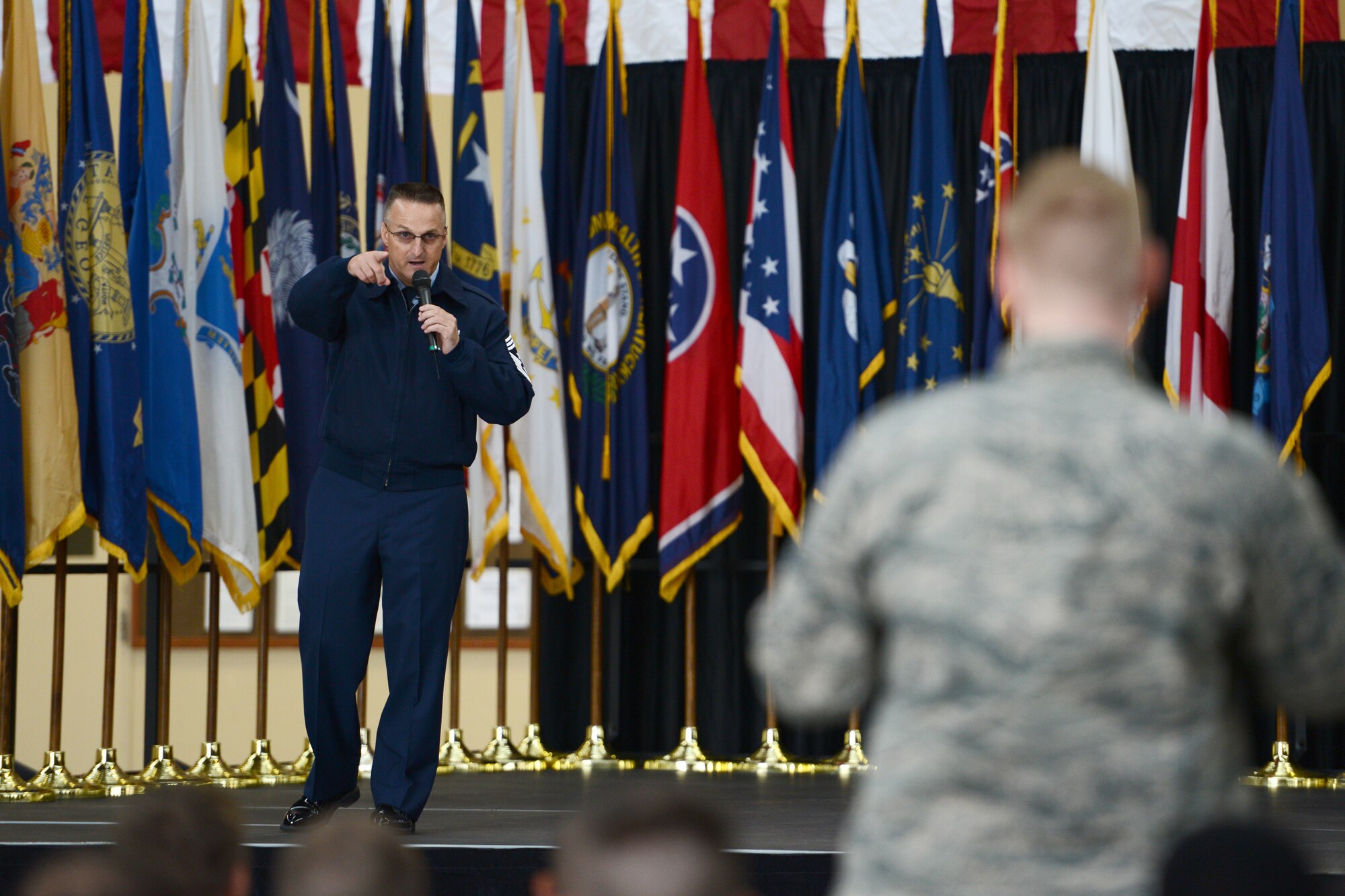 Chief Master Sgt. Harold Hutchison, Pacific Air Force command chief, answers an Airman’s question during an all-call at Yokota Air Base, Japan, Oct. 23, 2014. Hutchison answered direct questions from Airmen during his first tour of Yokota as the PACAF command chief. (U.S. Air Force photo by Staff Sgt. Cody H. Ramirez/Released)