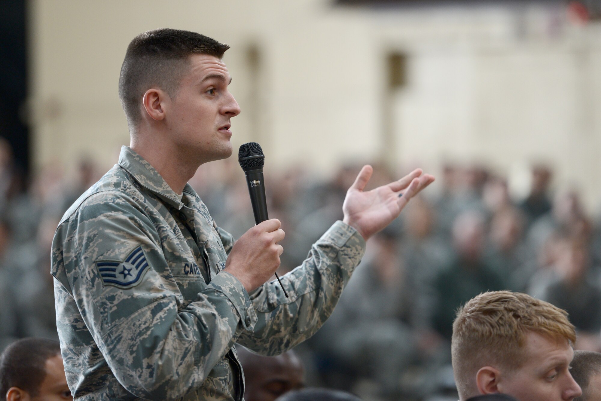 An Airman refers a question to Chief Master Sgt. Harold Hutchison, Pacific Air Force command chief, during an all-call at Yokota Air Base, Japan, Oct. 23, 2014. Many Airmen had the opportunity to present topics that concerned them with the command chief. (U.S. Air Force photo by Staff Sgt. Cody H. Ramirez/Released)