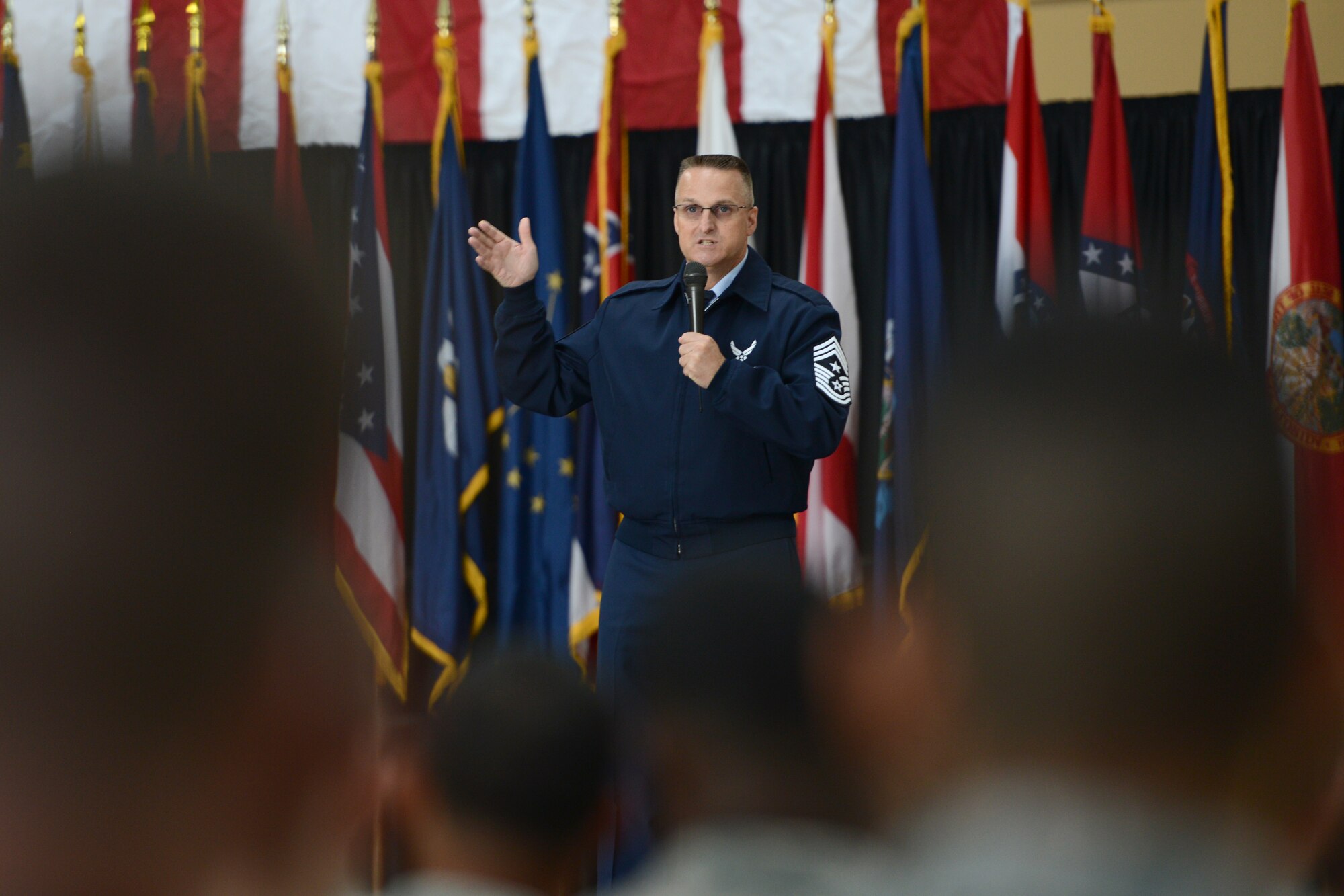 Chief Master Sgt. Harold Hutchison, Pacific Air Force command chief, speaks to a room full of Airmen at Yokota Air Base, Japan, Oct. 23, 2014. Hutchison said his true job as command chief is to serve the thousands of Airmen in PACAF and ensure they can succeed in their vital missions. (U.S. Air Force photo by Staff Sgt. Cody H. Ramirez/Released)