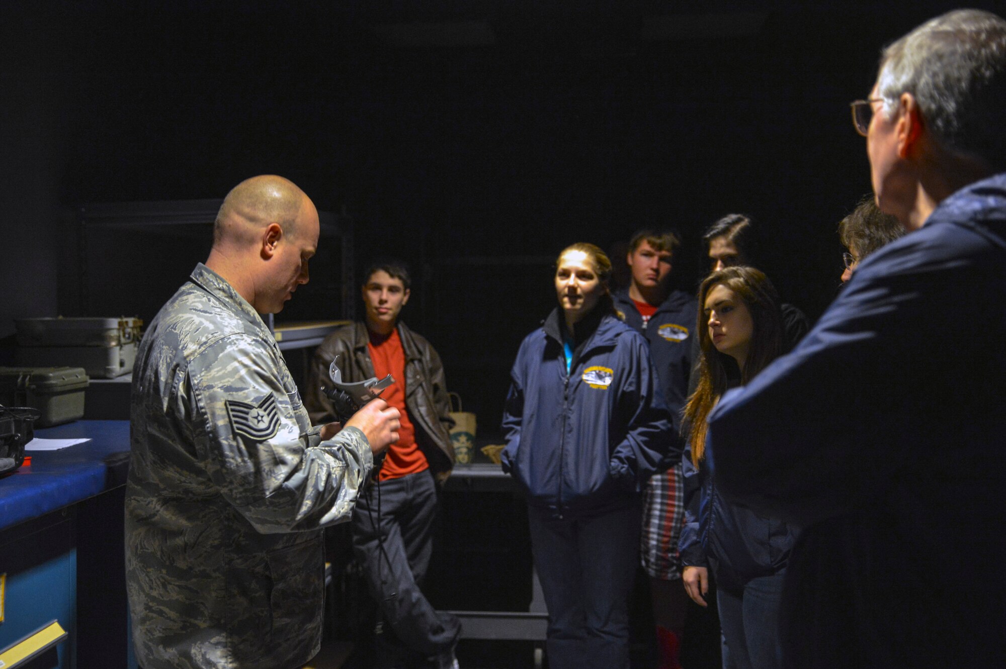 Tech. Sgt. Christopher Owen, 62nd Operations Support Squadron NCO in charge aircraft operations, shows students from the Aviation Explorer Post 1735 a set of night vision goggles October 25, 2014, during their tour of Joint Base Lewis-McChord, Wash. Owen greeted the students and showed them different items Airmen working in the aircrew flight equipment shop prepare for aircrew members prior to flying a C-17 Globemaster III from McChord Field. (U.S. Air Force photo/Airman 1st Class Keoni Chavarria)