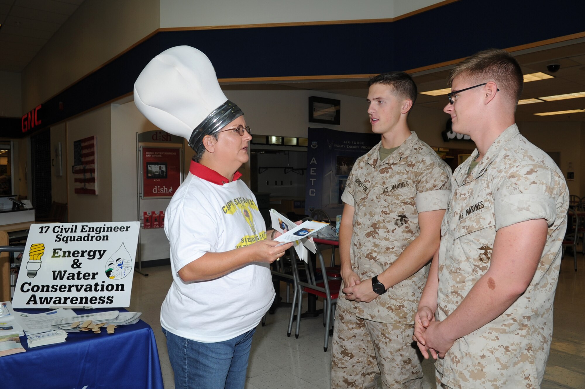 GOODFELLOW AIR FORCE BASE, Texas -- Mary C. Lumsdon, 17th Civil Engineer Squadron base energy manager, talks to Marine Corps Pfcs. Thomas K. Johnston and Anthony T. Keal, Marine Corps Detachment students, about Energy Awareness in the Exchange Concession Area Oct. 17. Other events during the month included passing out flyers at the gates and talking to children at the School Age Program. (U.S. Air Force photo/ Staff Sgt. Laura R. McFarlane)
