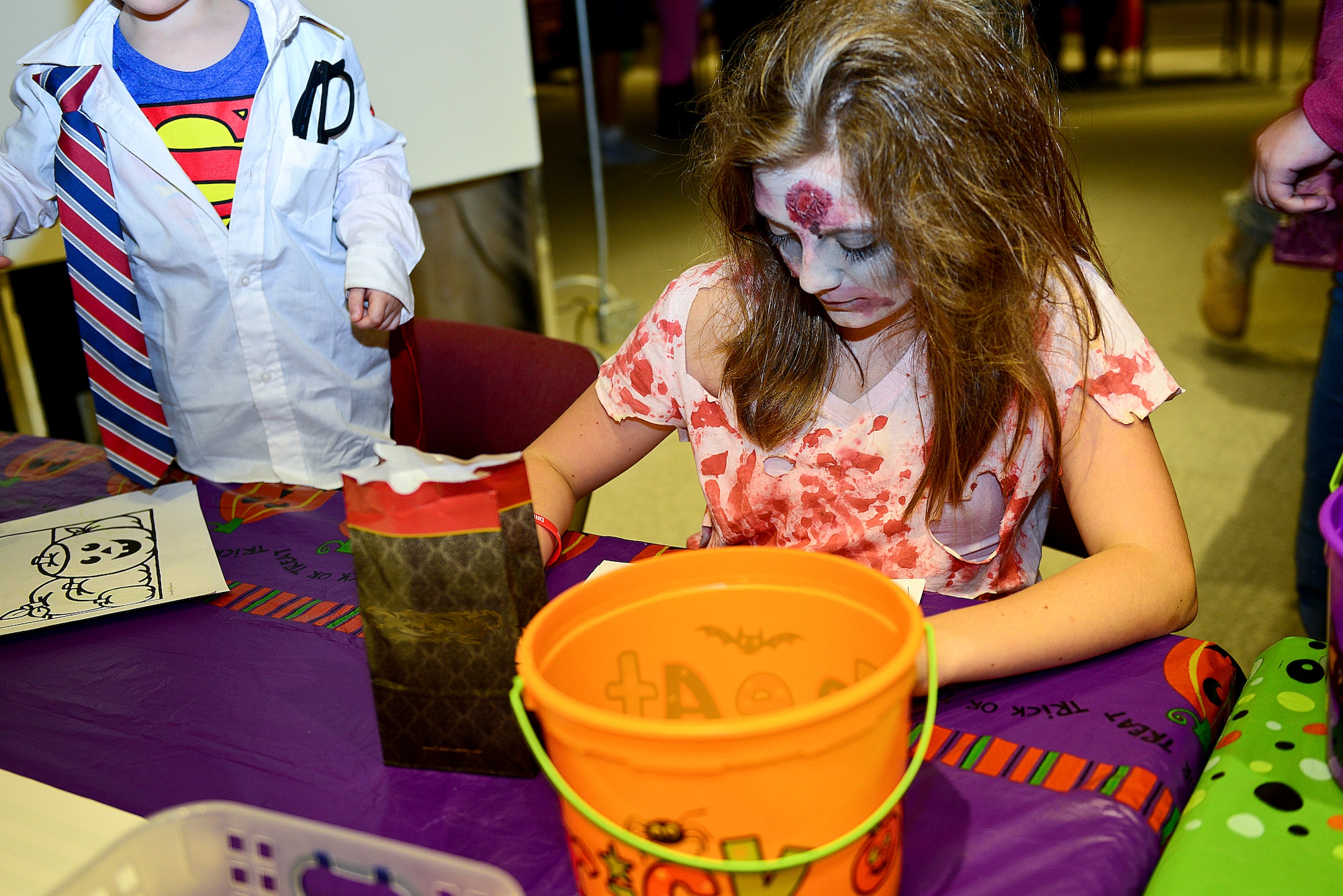 Caitlyn Wommack, 10-year-old daughter of U.S. Army Sgt.1st Class George Wommack, U.S. Army Training and Doctrine Command operations non-commissioned officer, colors during the Night at the Transportation Museum event at Fort Eustis, Va., Oct. 27, 2014. The family-friendly Halloween event taught Fort Eustis community members about the history of transportation while having fun. (U.S. Air Force photo by Airman 1st Class Kimberly Nagle/Released)
