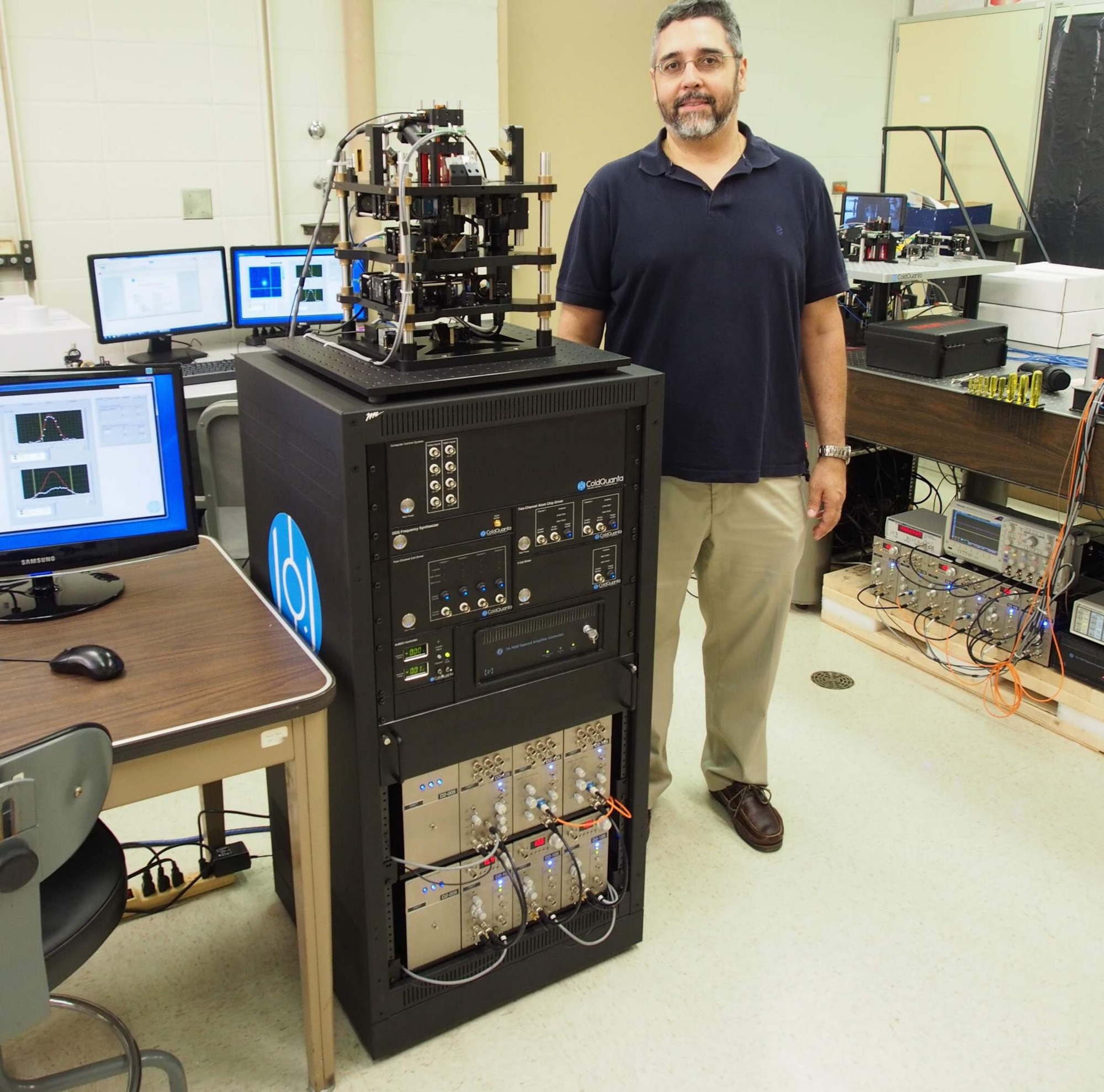 Dr. Jeffrey Yepez, researcher, Air Force Research Laboratory Directed Energy Directorate and leader of the joint AFRL and University of Hawaii Manoa quantum computing group received two new table-top quantum computing systems to trap and study the behavior of atoms in their condensed, pristine state.The new systems, delivered by cold-atom technology developer, ColdQuanta, provide researchers with a lower cost, in house opportunity to study the mysteries of quantum physics. (Air Force photo)