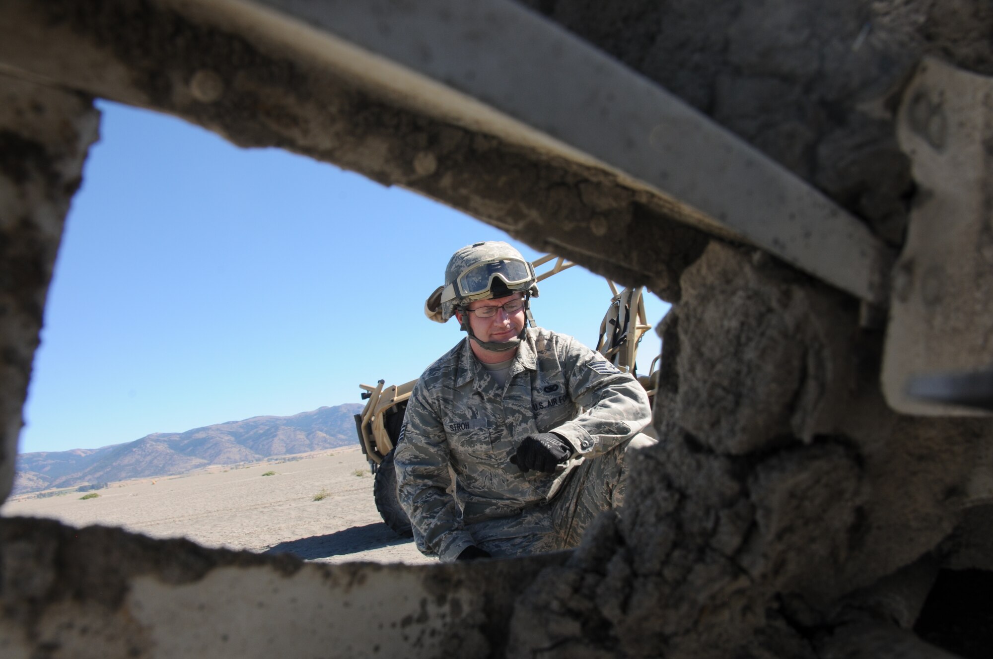 Staff Sgt. Brandon Stroh a self-professed history buff, looks over a piece of wreckage and tries to determine the aircraft type. Bartholomew, the base historian, determined that both a Corsair and a Helldiver crashed into the lake and says there may be others as well.  (U.S. Air National Guard photo by Tech. Sgt. Jefferson Thompson)