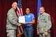 Fa’alupe Alford, 33rd Aircraft Maintenance Squadron commanders support staff, is presented the Air Education and Training Command 2014 National Image, Inc. Meritorious Service award from Col. Todd Canterbury, 33rd FW commander, and Chief Master Sgt. Scott Berge, 33rd FW command chief, on Eglin Air Force Base, Fla., Oct 17, 2014. Alford has been a community leader for both Navarre and Niceville, Fla. She has been an advocate from the 33rd FW honorary commander program and the key spouse programs at Eglin AFB and Hurlburt Field, Fla., which are vital to family readiness.  She has also been an avid supporter of the Air Force Enlisted Village and the Eglin AFB sexual assault prevention and response program. (U.S. Air Force photo/Staff Sgt. Marleah Robertson)
