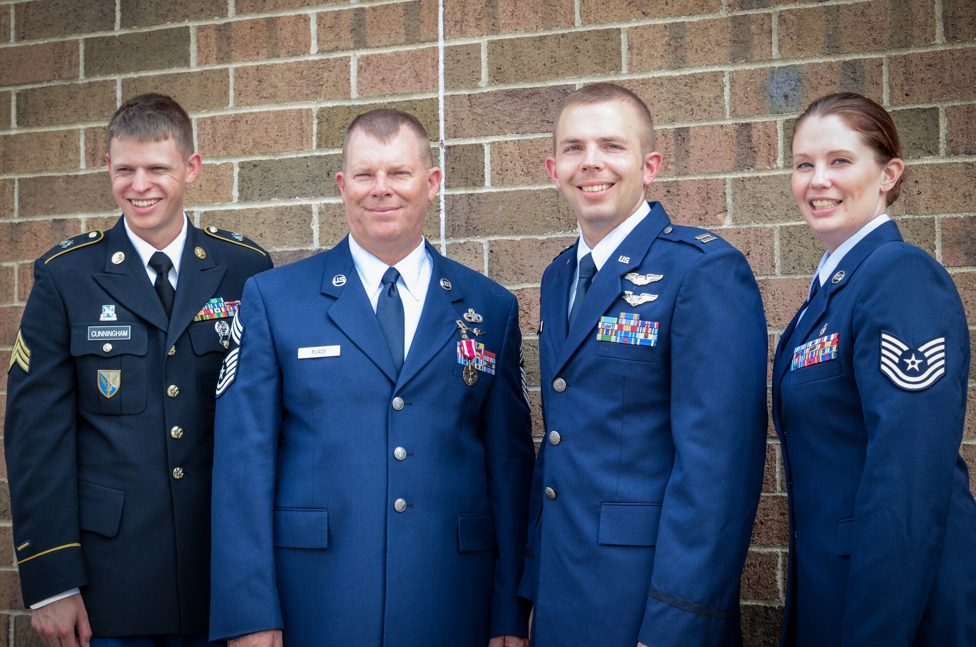 From left to right, the chief's nephew, Army Sgt. Samuel Cunningham; Chief Master Sgt. Dale Place;  his son, Capt. Lee Place; and his daughter Tech. Sgt. Rebecca Place. (Air Force Photo/Master Sgt. Eric Amidon)