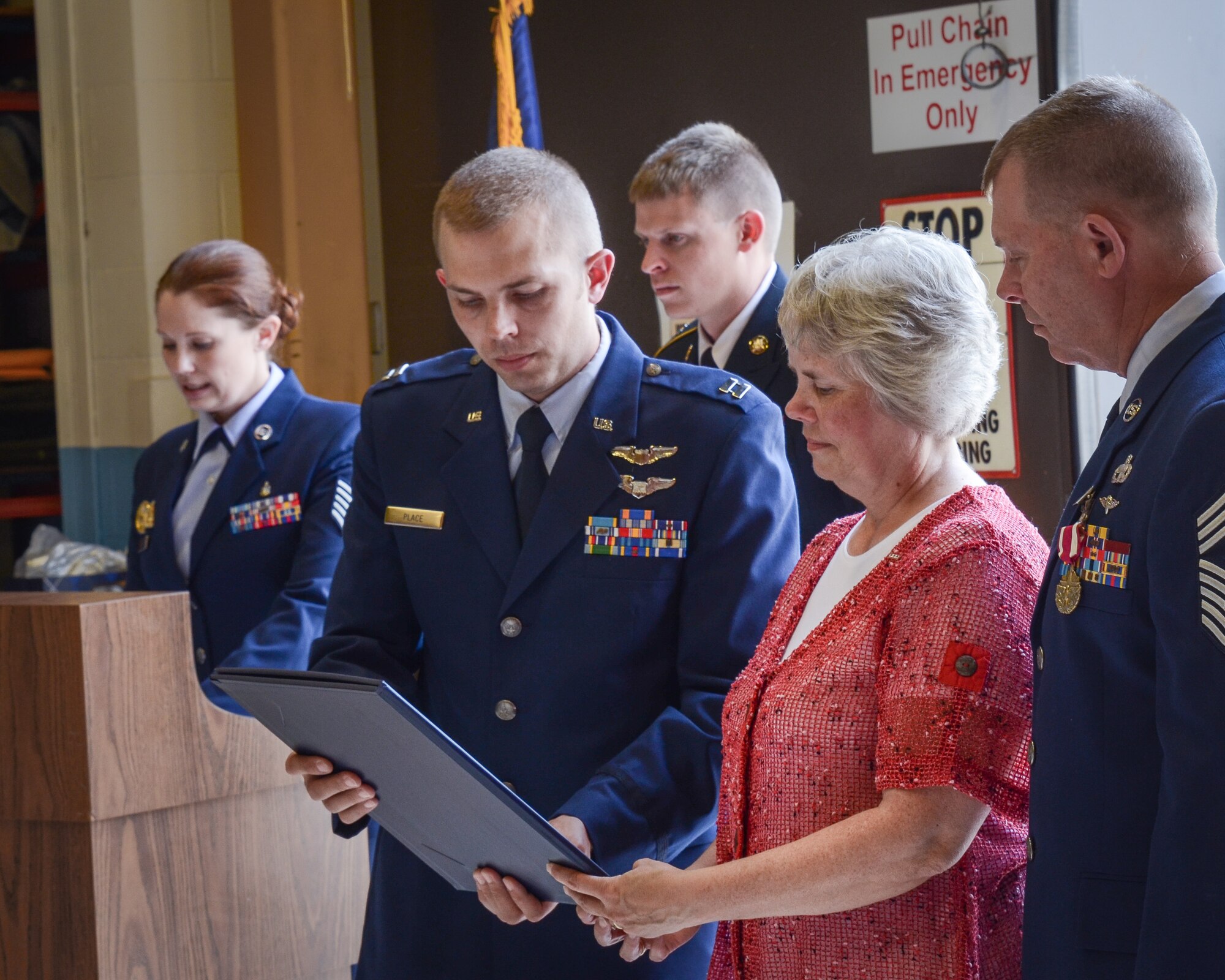 During ceremony, from left to right, the chief's daughter, U.S. Air Force Tech. Sgt. Rebecca Place; his son, USAF Capt. Lee Place; his nephew, Army Sgt. Samuel Cunningham; his wife, Kay Place; and Chief Master Sgt. Dale Place. (Air Force Photo/Master Sgt. Eric Amidon)