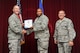 Lt. Col. Rodrick Webb, 33rd Maintenance Group deputy commander, accepts the 33rd FW civilian of the quarter category III award on behalf of Ms. Keisha Mitchell, 33rd MXG resource advisor, from Col. Todd Canterbury, 33rd FW commander, and Chief Master Sgt. Scott Berge, 33rd FW command chief, on Eglin Air Force Base, Fla., Oct 17, 2014. Mitchell guided the 33rd MXG through a successful close-out by utilizing $681K in funding resulting in a flawless execution. (U.S. Air Force photo/Staff Sgt. Marleah Robertson)