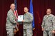 Capt. Brian Saari, 33rd Operations Group chief of F-35 intelligence formal training unit, accepts the 33rd FW civilian of the quarter category II award on behalf of Terry Youngblood, 33rd OG special security representative, from Col. Todd Canterbury, 33rd FW commander, and Chief Master Sgt. Scott Berge, 33rd FW command chief, on Eglin Air Force Base, Fla., Oct 17, 2014. Youngblood renovated the wing’s special compartmented information database by revalidating the requirements for 49 billets and reviewed all required justifications which guaranteed program integrity. (U.S. Air Force photo/Staff Sgt. Marleah Robertson)
