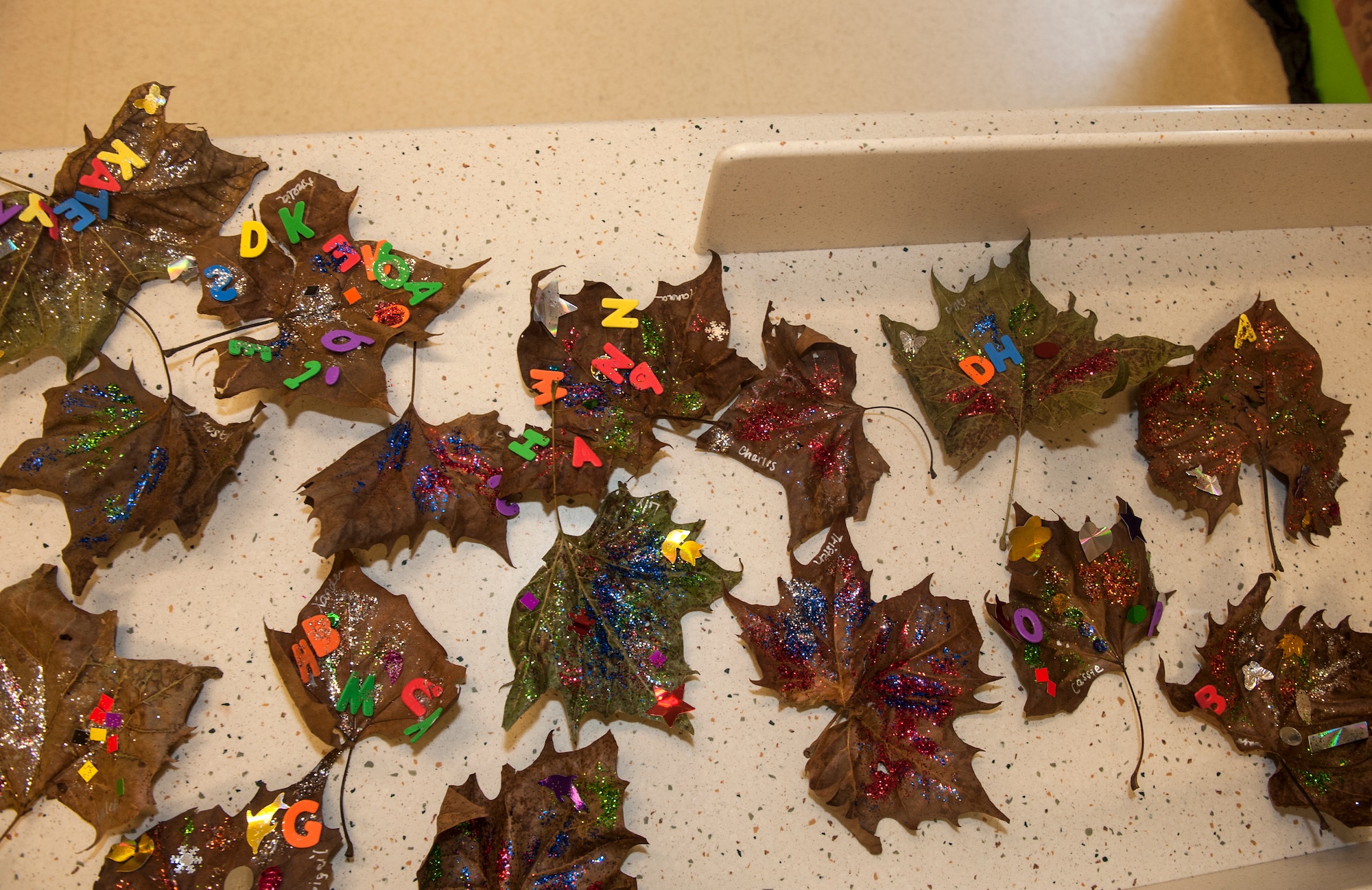 Decorated leaves sit on a table during the Child Development Center’s Fantastic Fall event Oct. 24, 2014, at Moody Air Force Base, Ga. Fantastic Fall provided an interactive way for children to explore the changes in the environment through arts and crafts. (U.S. Air Force photo by Senior Airman Jarrod Grammel/Released)
