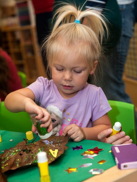 Aspen, daughter of U.S. Air Force Staff Sgt. Nicholas Nelson, decorates a leaf Oct. 24, 2014, at Moody Air Force Base, Ga. Aspen decorated leaves as part of Fantastic Fall, an event held by the Child Development Center. (U.S. Air Force photo by Senior Airman Jarrod Grammel/Released)

