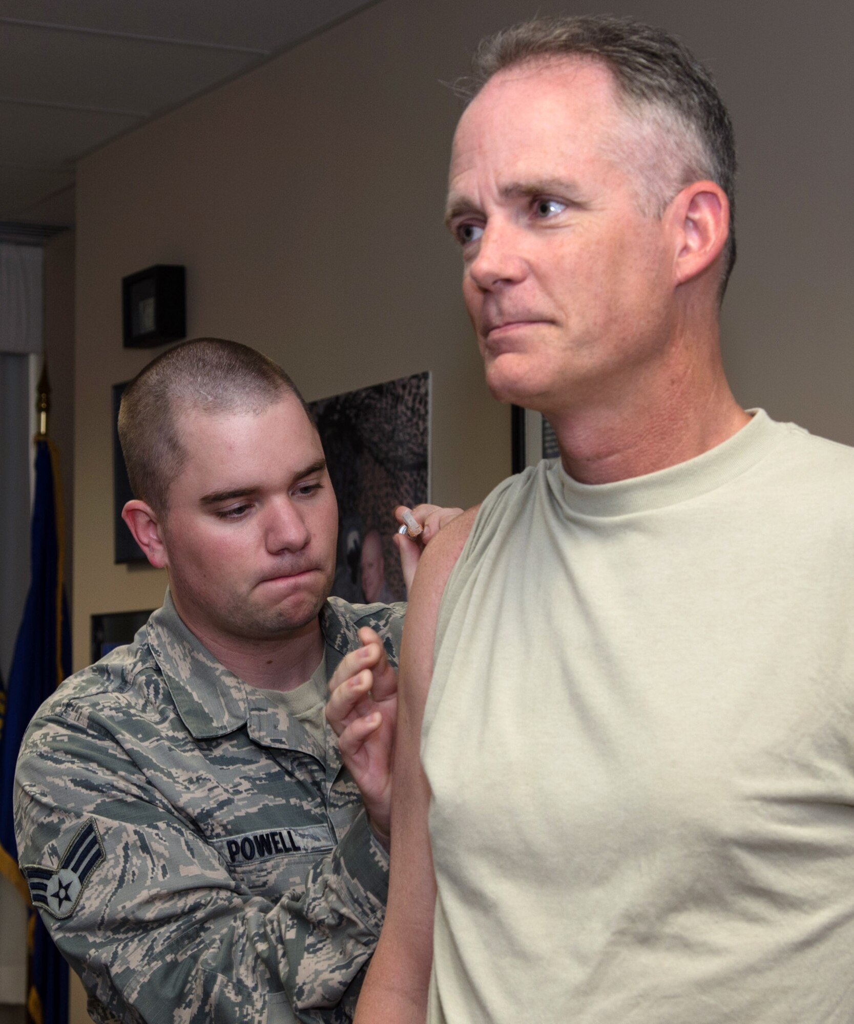 Col. Michael A. Vogel, 66th Air Base Group commander, receives his flu shot from Senior Airman Benjamin Powell of the 66th Medical Squadron Immunizations Clinic Oct. 23. The 66th Medical Squadron has received enough flu vaccine to begin immunizing active duty members. Being immunized can help protect personnel, as well as their family and co-workers from getting the flu. While the severity and timing of the annual flu outbreak can be unpredictable, getting immunized early will provide protection for the entire season. (U.S. Air Force photo by Mark Herlihy)