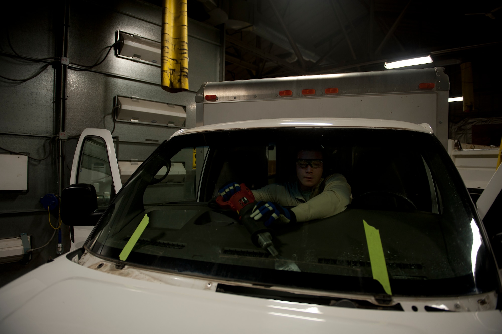Staff Sgt. Keegan Chaptintovey, 5th Logistics Readiness Squadron vehicle maintenance allied trades NCO in charge, removes the window shield from a vehicle on Minot Air Force Base, N.D., Oct. 17, 2014. Vehicle mechanics are responsible for the maintenance of all government-owned vehicles on base. (U.S. Air Force photo/Senior Airman Brittany Y. Bateman)