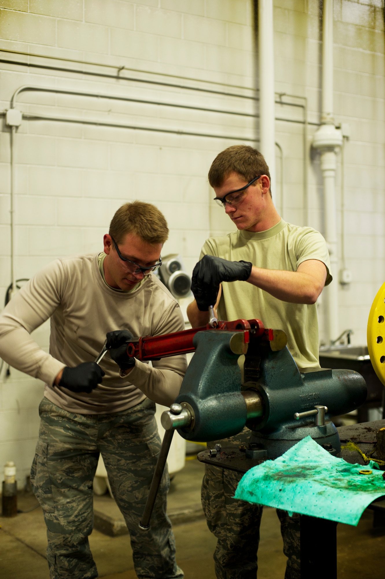Senior Airman Jordan Gehler, 5th Logistics Readiness Squadron vehicle maintenance journeyman, and Airman 1st Class Tanner Leonard, 5th LRS vehicle maintenance apprentice, rebuilds a cylinder on Minot Air Force Base, N.D., Oct. 17, 2014. Airmen from the 5th LRS vehicle maintenance flight repair and maintain various types of vehicles to ensure Minot AFB stays mobile. (U.S. Air Force photo/Senior Airman Brittany Y. Bateman) 