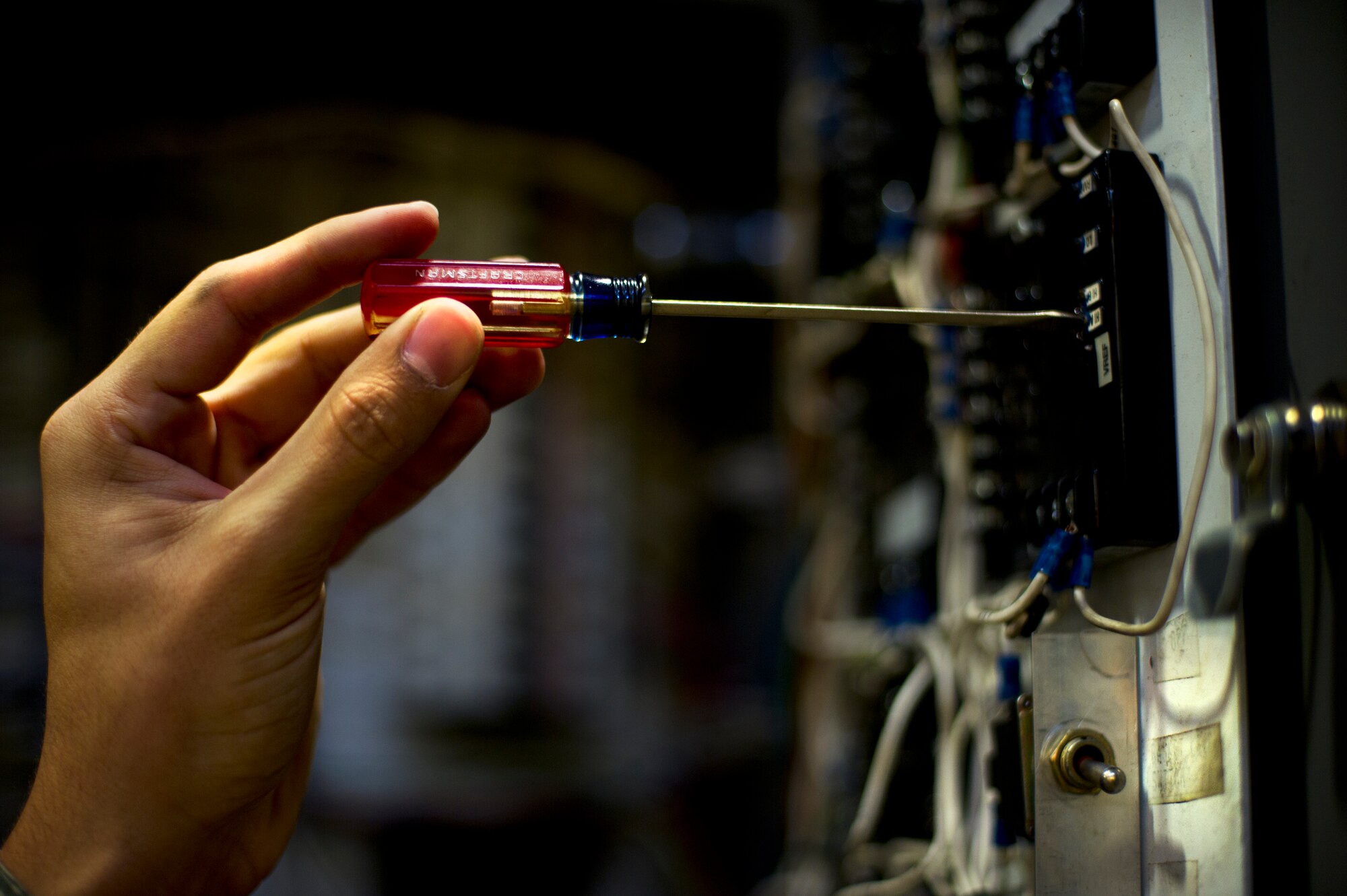 Airman Dalton Bridges, 5th Logistics Readiness Squadron vehicle maintenance apprentice, works on a vehicle on Minot Air Force Base, N.D., Oct. 17, 2014. Airmen from the 5th LRS vehicle maintenance flight repair and maintain various types of vehicles to ensure Minot AFB stays mobile. (U.S. Air Force photo/Senior Airman Brittany Y. Bateman) 