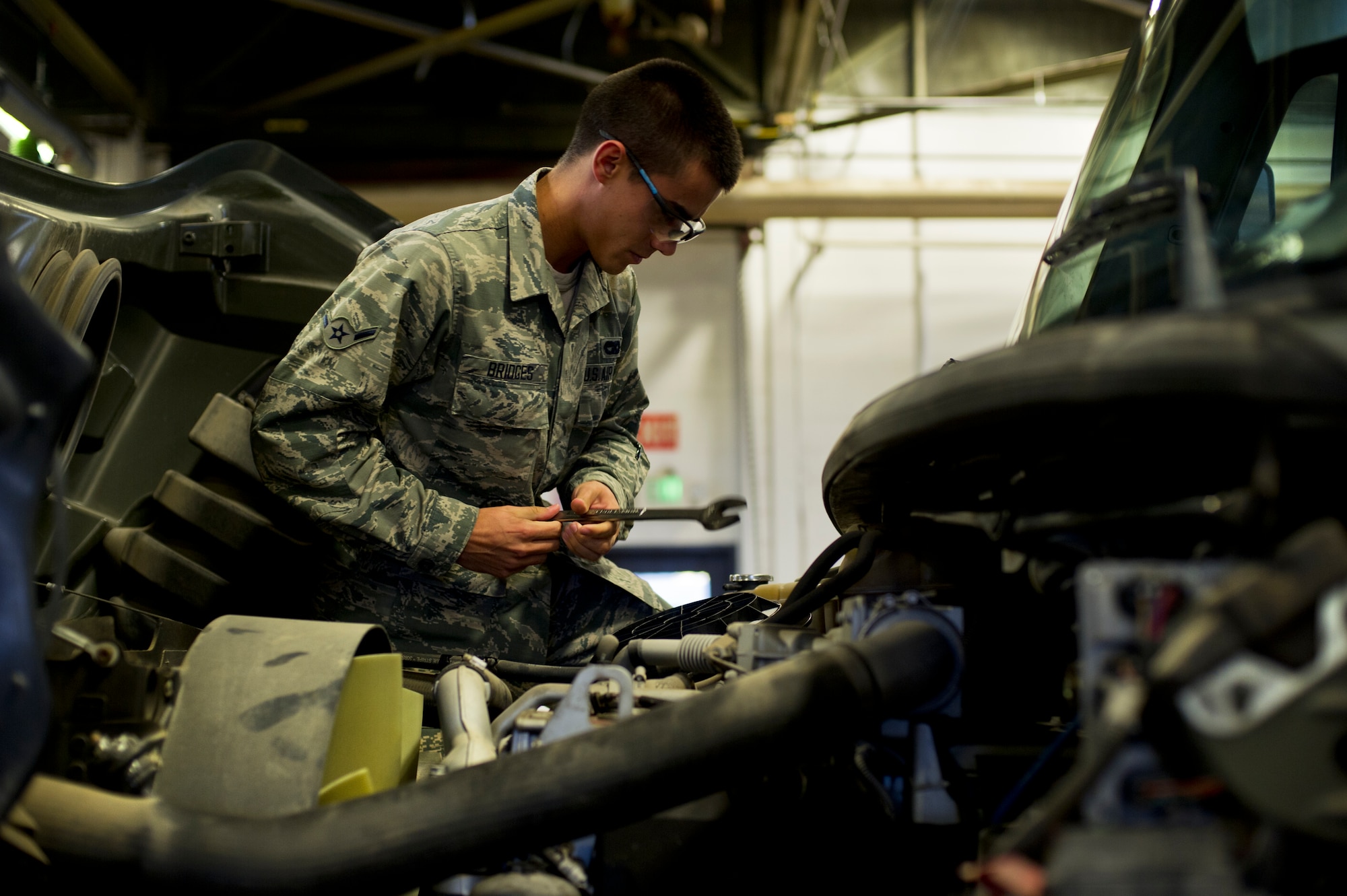 Airman Dalton Bridges, 5th Logistics Readiness Squadron vehicle maintenance apprentice, works on a vehicle on Minot Air Force Base, N.D., Oct. 17, 2014. Airmen from the 5th LRS vehicle maintenance flight repair and maintain various types of vehicles to ensure Minot AFB stays mobile. (U.S. Air Force photo/Senior Airman Brittany Y. Bateman) 