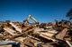 Construction workers hose down and remove pieces of a demolished building Oct. 28, 2014, at Moody Air Force Base, Ga. The site housed buildings belonging to the 23d Civil Engineer Squadron, who will move back in when a new building is constructed in 2016. (U.S. Air Force photo by Airman 1st Class Ryan Callaghan/Released)