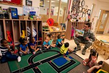 U.S. Air Force Senior Airman Julian Broaddus, 23d Civil Engineer Squadron engineering journeyman, shows pictures from a book during a reading at the Child Development Center II Oct. 28, 2014, at Moody Air Force Base, Ga. Members from the CES read energy and water conservation related stories to Pre-K classes. (U.S. Air Force photo by Senior Airman Olivia Bumpers/Released)