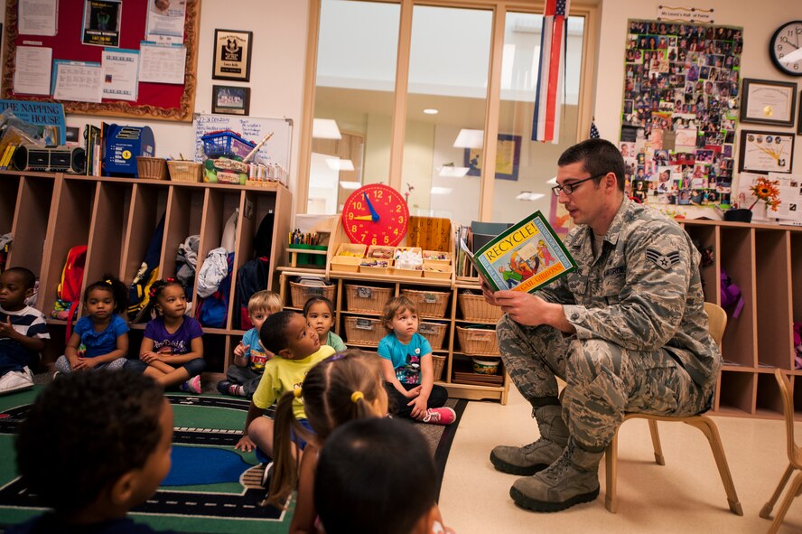 U.S. Air Force Senior Airman Julian Broaddus, 23d Civil Engineer Squadron engineering journeyman, reads a book to children at the Child Development Center II Oct. 28, 2014, at Moody Air Force Base, Ga. Because October is Energy Action Month, the CES held various events to educate Airmen and their families on how to make more energy-efficient choices. (U.S. Air Force photo by Senior Airman Olivia Bumpers/Released)