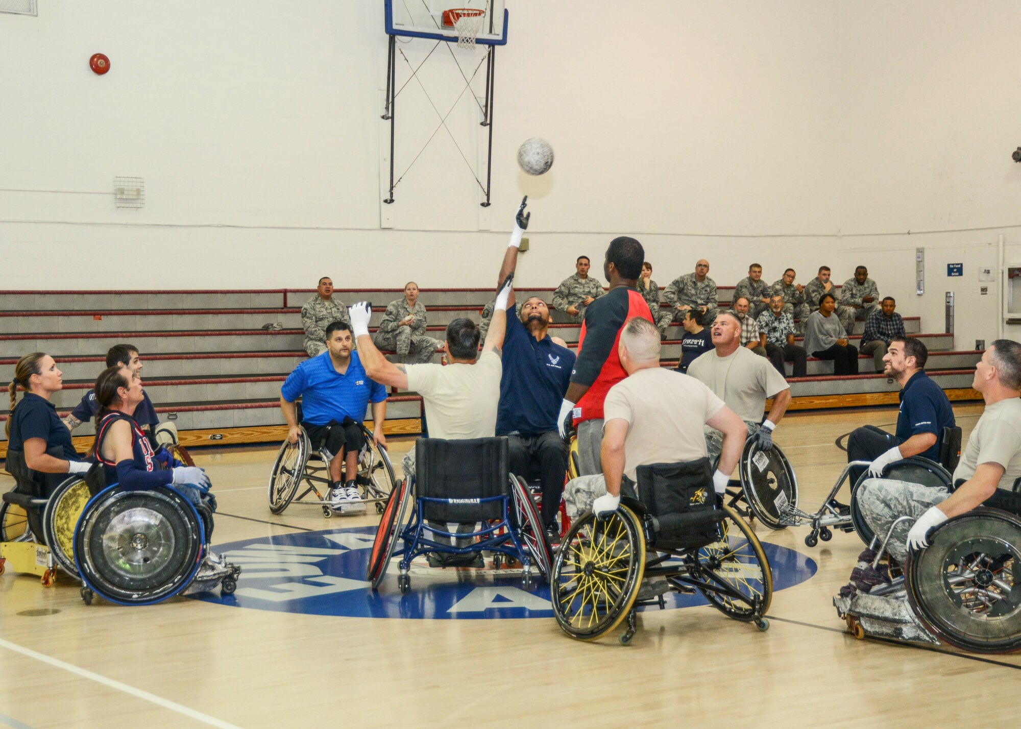Airmen and Triumph Foundation members begin a wheelchair rugby game with the tip off in the Rosburg Fitness Center Oct. 27. Triumph Foundation visited Team Edwards as part of Disability Employment Awareness Month. The foundation's mission is to help people who suffer spinal chord injuries restore their lives. (U.S. Air Force photo by Rebecca Amber)
