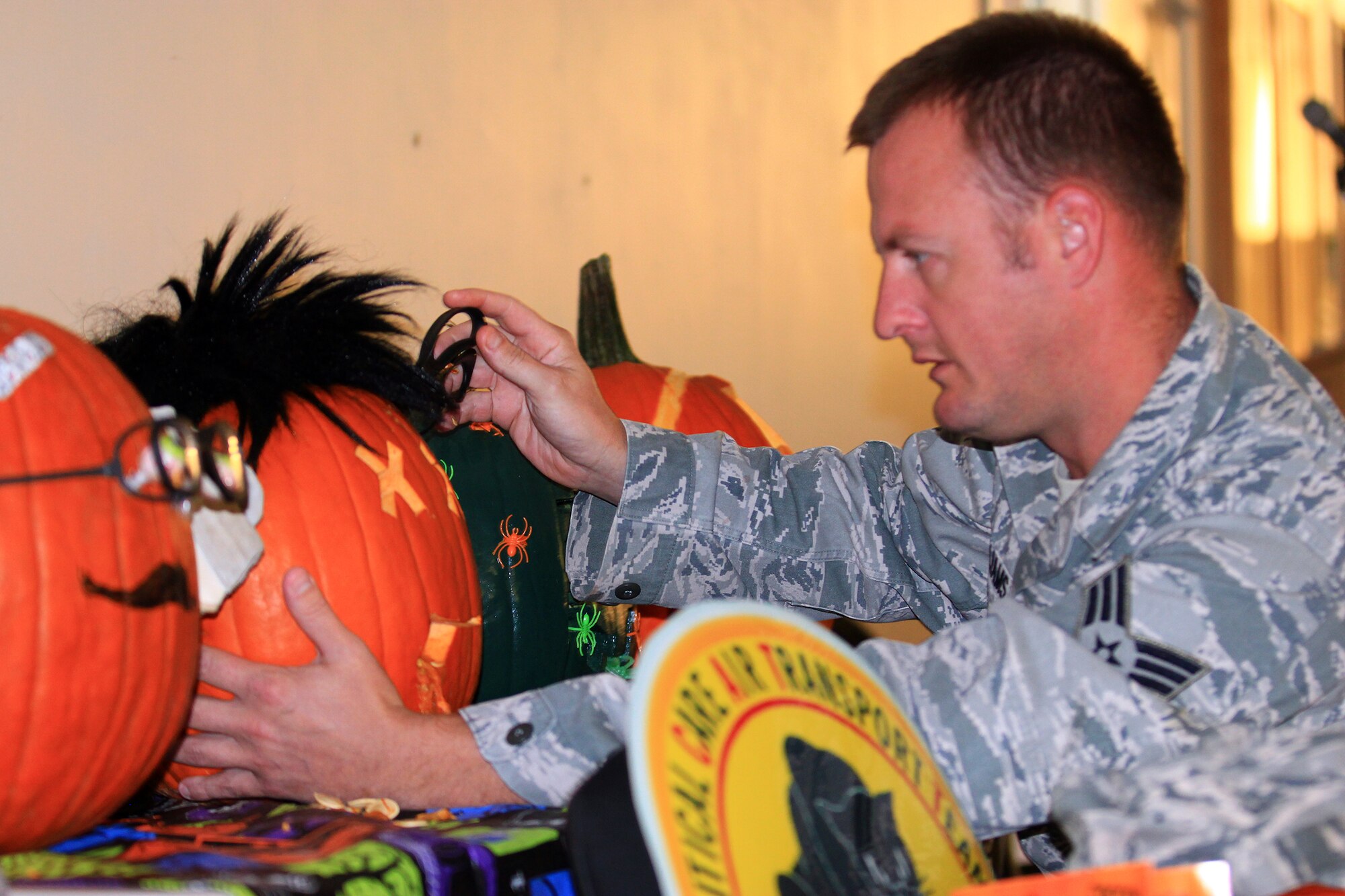 WRIGHT-PATTERSON AIR FORCE BASE, Ohio – Senior Airman Daniel Williams, 445th Aeromedical Staging Squadron diagnostics imaging journeyman, puts the finishing touches on his pumpkin during the ASTS pumpkin carving contest Oct. 5, 2014. The event was hosted by the Airman's Council. (U.S. Air Force photo/Tech. Sgt. Patrick O'Reilly)