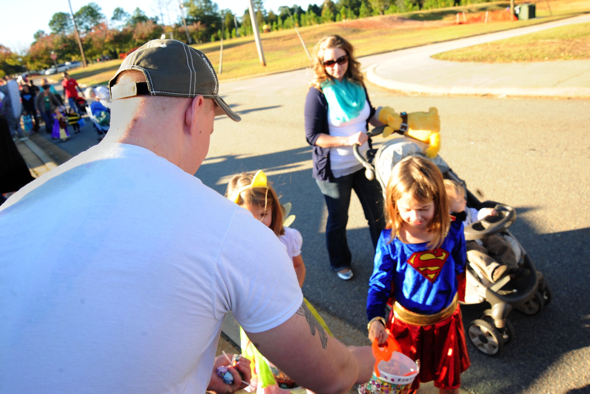 U.S. Air Force Senior Airman Quest Largent, 20th Fighter Wing nonjudicial punishment paralegal, passes out candy during the 20th Force Support Squadron Boo Bash at Shaw Air Force Base, S.C., Oct. 25, 2014. Approximately 1,500 Team Shaw family members walked through the “Trunk-or-Treat” line for goodies. (U.S. Air Force photo by Airman 1st Class Michael Cossaboom/Released)