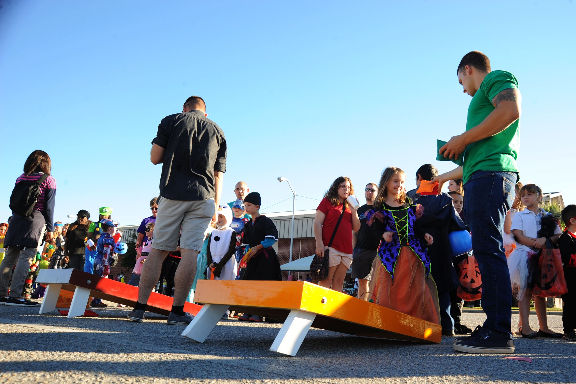 Members of Team Shaw play cornhole during the 20th Force Support Squadron Boo Bash at Shaw Air Force Base, S.C., Oct. 25, 2014. Ten groups from across base decorated vehicles and passed out donated candy to members of Team Shaw to provide a safe trick-or-treating environment. (U.S. Air Force photo by Airman 1st Class Michael Cossaboom/Released)