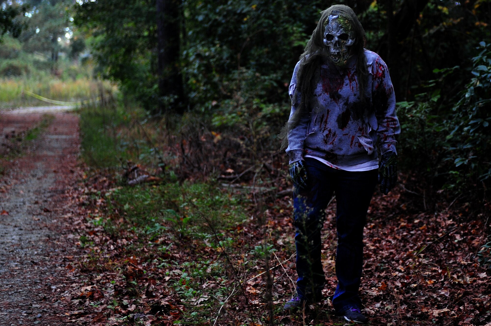 A zombie waits for unsuspecting runners during a Zombie 5K at Seymour Johnson Air Force Base, North Carolina, Oct. 24. (U.S. Air Force photo/Senior Airman John Nieves Camacho)
